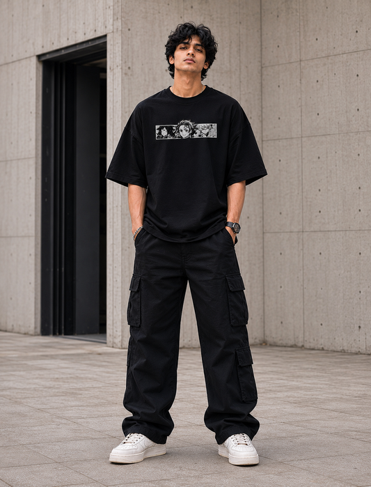 Kakusei Anime Graphic Unisex Oversized T-Shirt in black worn by male model standing front view with relaxed streetwear fit.