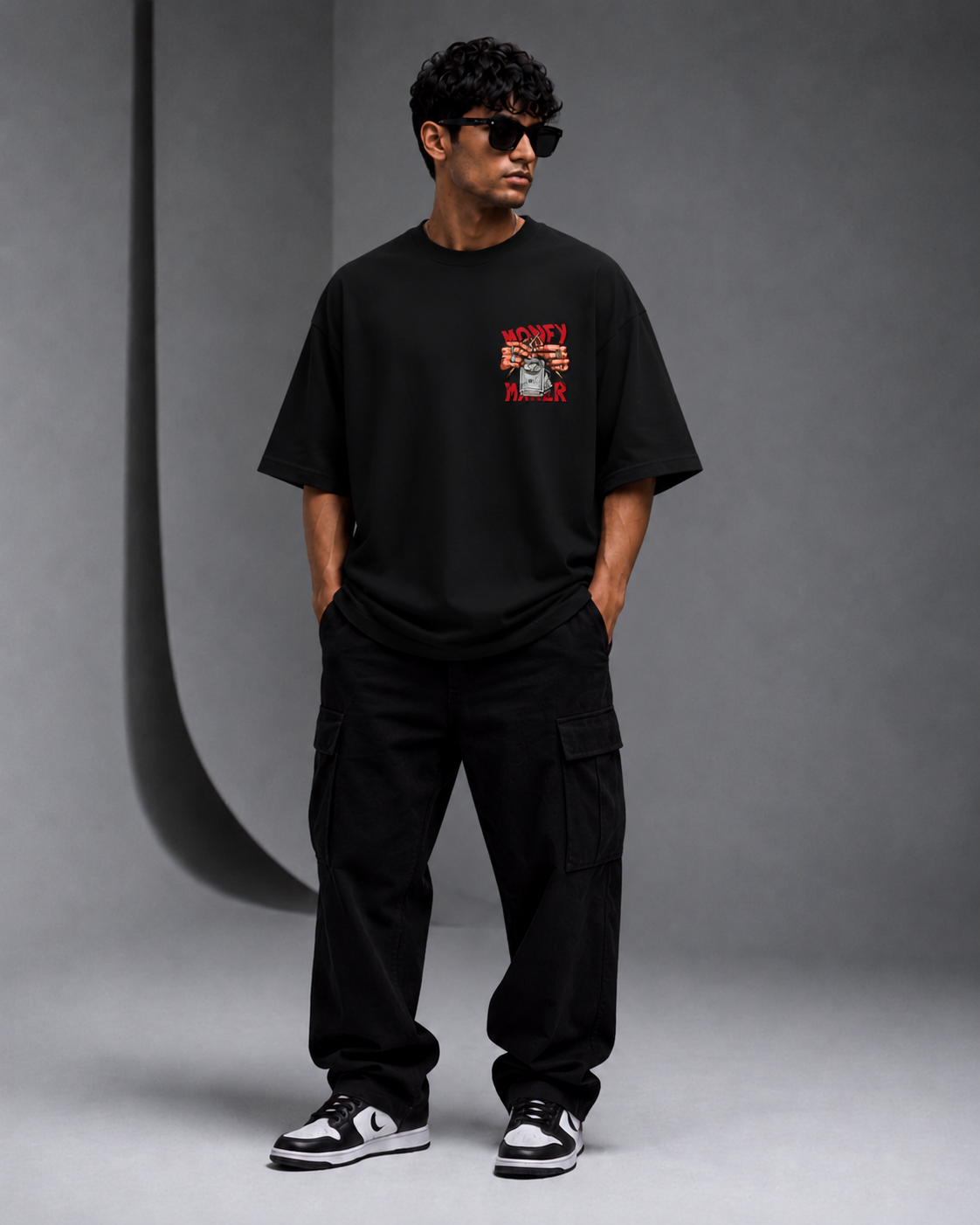 Male model wearing Oversoul Money Maker Graphic Unisex Oversized T-Shirt black front view