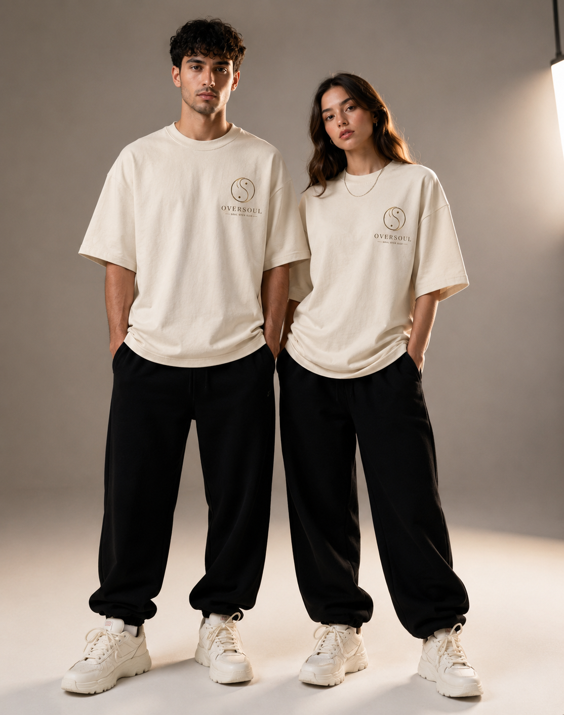 Male and female models wearing Oversoul Dragon Unisex Oversized T-Shirt front view.