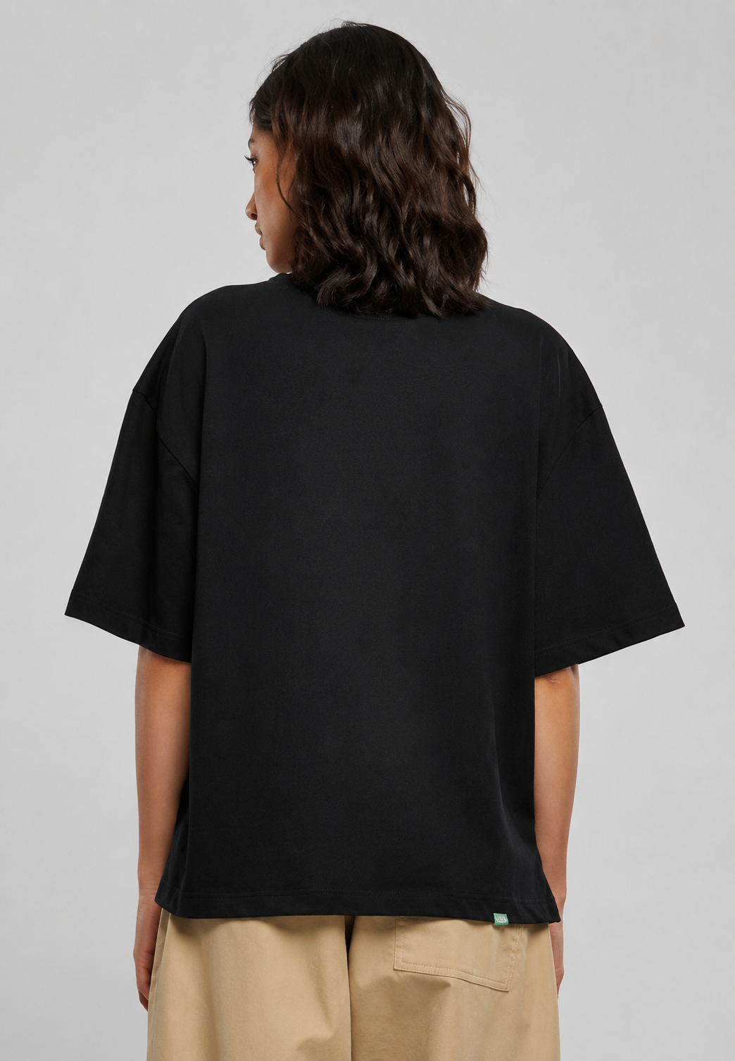 Female model showing back view of Oversoul Ruby Lips Graphic Unisex Oversized T-Shirt in black