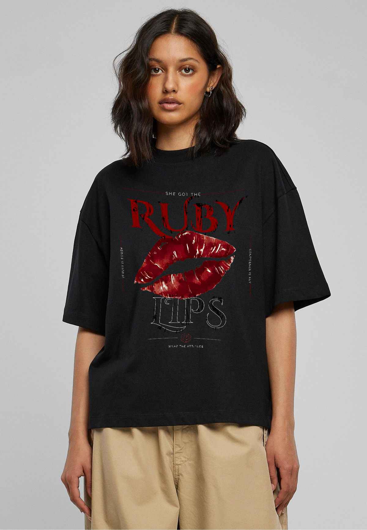 Female model wearing Oversoul Ruby Lips Graphic Unisex Oversized T-Shirt in black front view